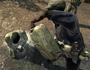 A militant dousing an African Villager with gasoline.