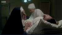 Sister Monica Joan assists at birth