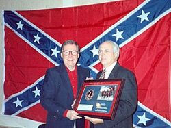 Mitch McConnell in front of the Confederate battle flag