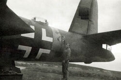 An RAF ground crew inspects 41-17790, which has the Nazi markings it wore for nearly two and a half years. [N 2]