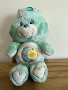 Bedtime Bear with a brown stitching outline on his belly badge and feetpads