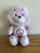 Share Bear with a brown stitching outline on her belly badge