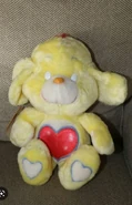 Yellow Loyal Heart Dog with Tenderheart Bear's belly badge and blank eyes