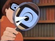 Camera-zoomed imaged of Velma with magnifying glass
