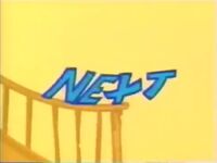 The "Next" letters are sliding down the banister on some stairs, crash into a wall, and leave a huge print.