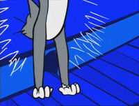 Tom tries to catch Jerry, but he escapes into his mouse hole, causing Tom to hit the wall.
