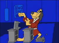 Phooey flies in and chops a cinder block in two. Half of the block lands on his foot.