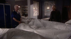 Charlie shows Denny the bodies of the explosion's victims.