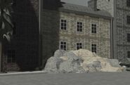 Rubble in front of a building.