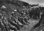 Mud stained British soldiers at rest