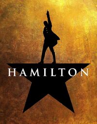 The Hamilton poster has a gold background, featuring a silhouetted man acting as the top point on a black 5 pointed star. The white "Hamilton" logo sits across the middle of the star.
