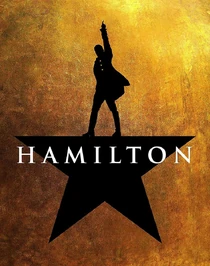 w:c:hamiltonmusical:Hamilton (194 KB) The Hamilton poster, featuring a man standing on top the white show logo, on a black 5 pointed star, which is on a gold background