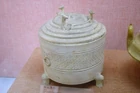 A footed Western-Han white ceramic wine warmer with animal-head figurines decorating its lid