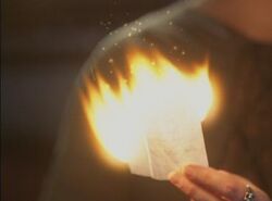 Burning a written spell.