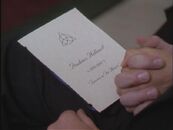 Located on the program to Prue's funeral. ("Charmed Again")