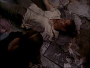 Phoebe lying dead in ruins