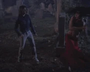 Paige kicking Phoebe as a vampire.