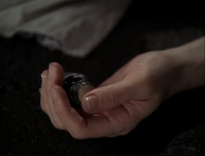 The potion bottle in Paige's hand.