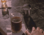 Prue moving the cream into her coffee.