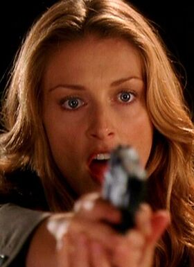 Sheridan holds a gun as she tells Piper and Phoebe to freeze after destroying Black Jack Cutting