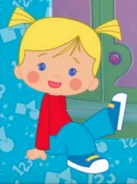 Chloe in an unused red shirt, blue pants and shoes sitting down