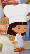Danny in her culinary costume (Easy as Cake and Pizza Party)