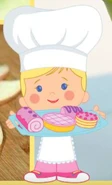 Chloe as a chef with a tray of baked goods