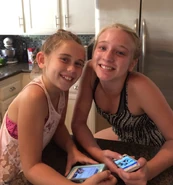 Chloe and Carys in 2015 with their real-life 'Lovely Carrot', their iPhones