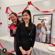 Kara & Jennifer next to Open Heart Poster @ PB Feb 2019 Party