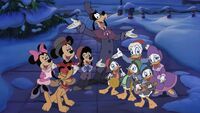 Goofy and his friends sing Christmas carols.