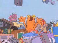 Garfield "swims" about in the things he wished for on the gift-giving machine.