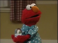 Elmo with the snow globe.