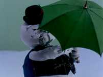 Sam unfolds his umbrella