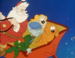 Heathcliff and Spike riding with Santa.