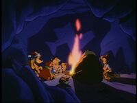 The families have a campfire in a nearby cave...