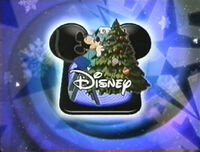 The Disney Channel logo from 1997 to 2002, with Mickey Mouse decorating his Christmas tree.