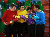 The Wiggles holding Wags' bones