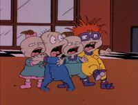 The Rugrats are scared when they see Chas coming down the chimney.