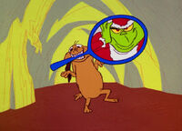 Max holding a mirror as the Grinch puts on his costume.