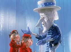 Snow Miser towers over elves