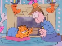 Jon wakes Garfield out of his dream.