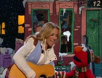 Elmo and Sheryl Crow sing "It's Almost Christmas".