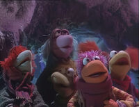 Mokey and her friends overhear the Muppets singing...