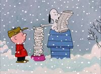 Snoopy reading the newspaper. (A Charlie Brown Christmas)