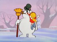 Karen places Hinkle's hat on Frosty's head...