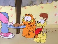 Grandma gives some of her dinner to Garfield and Odie.