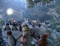 The Snowman and the woodland animals sing "Caroling, Caroling".