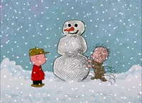 Pig-Pen building a snowman.
