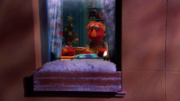 After the story, Louie tucks Elmo in.