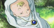 Kid de bebé, con el colgante de Schala, en el FMV de Chrono Trigger.
